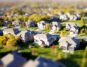 Real estate attorney in a modern, bright office points to a section of a contract while a couple listens intently, feeling...