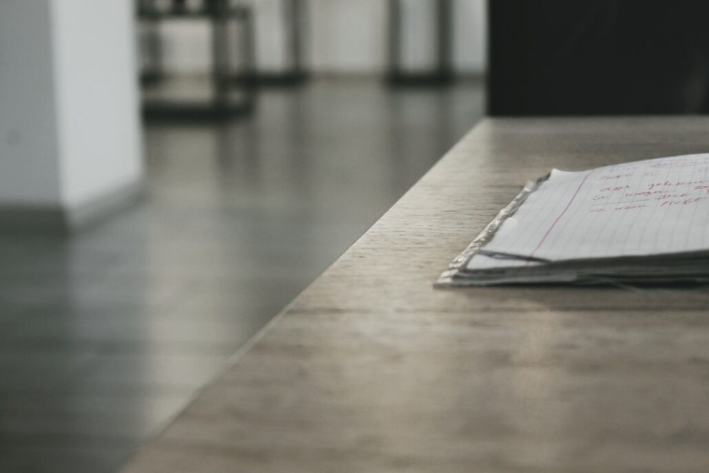 Bright, modern desk with neatly laid out architectural blueprints, a laptop, and a cup of coffee, symbolizing the planning...
