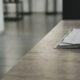 Bright, modern desk with neatly laid out architectural blueprints, a laptop, and a cup of coffee, symbolizing the planning...